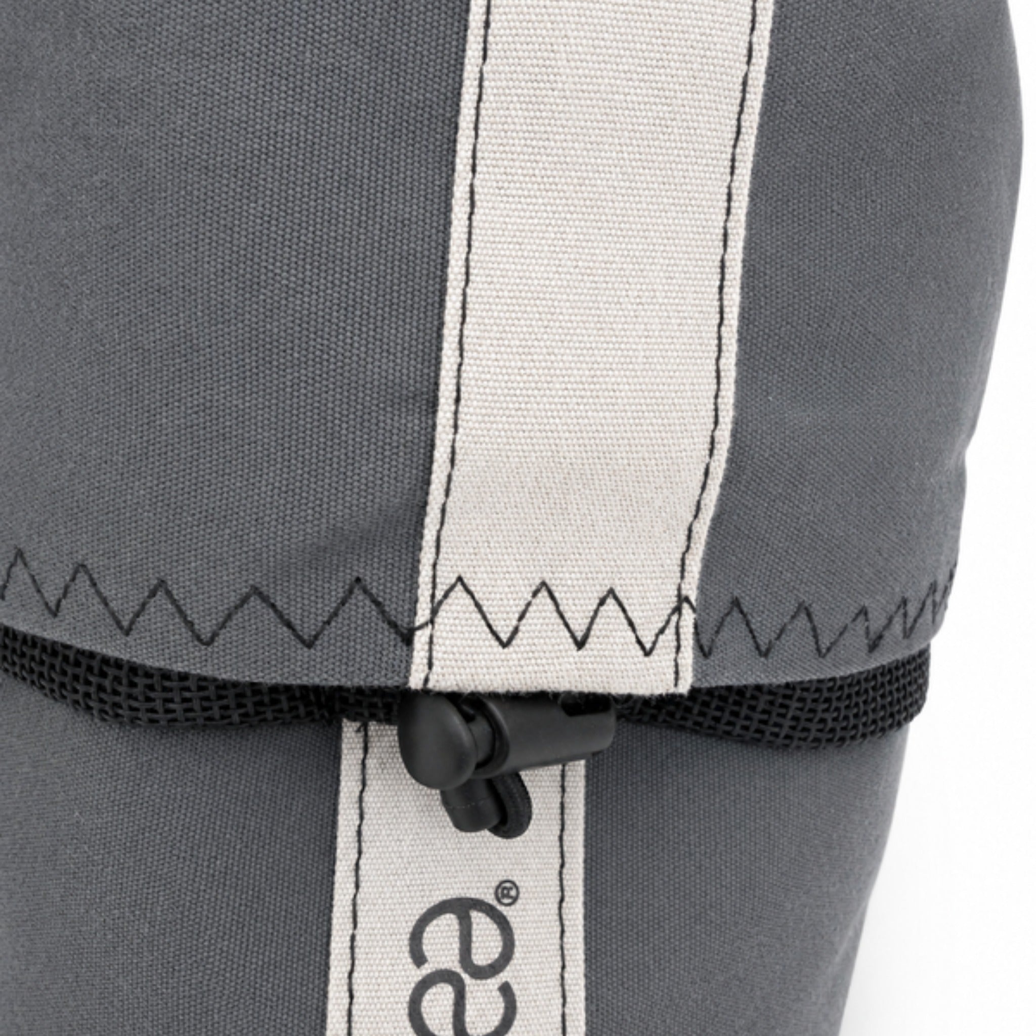 Close-up of the zigzag stitching, the reflective band and the drawcord lock of the winch cover