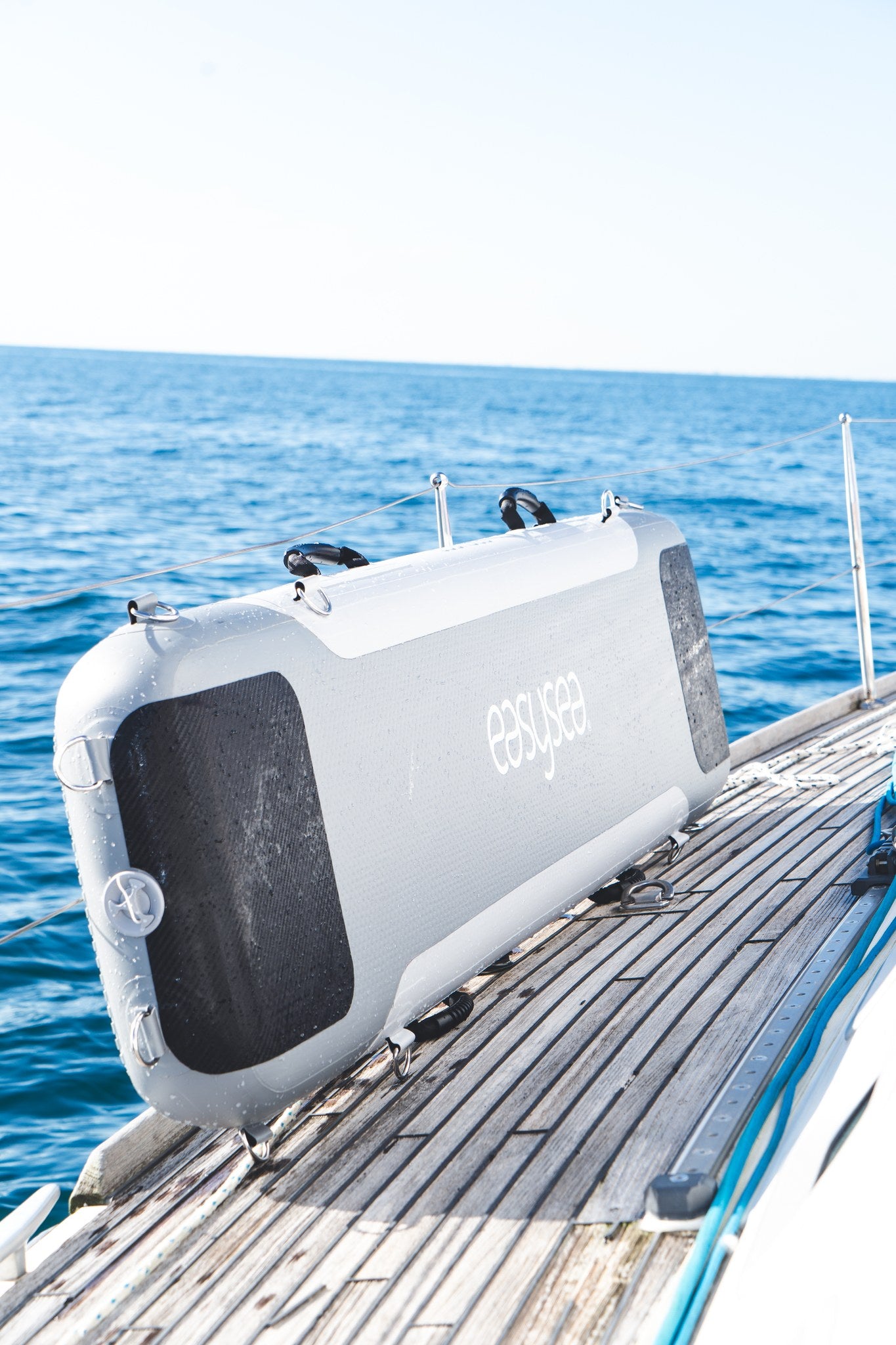 WAY2 inflatable gangway stowed on the side deck with the open sea behind